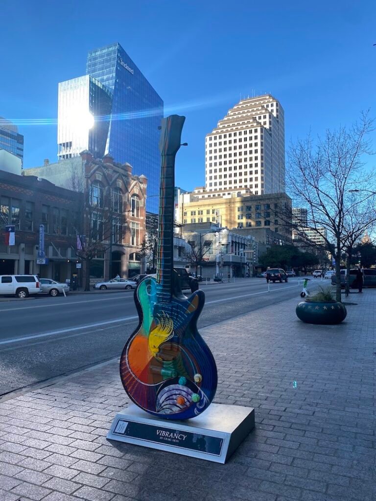 A multi-colored guitar statue in downtown Austin